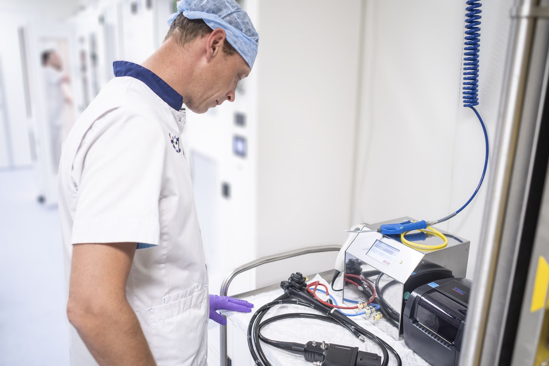 A man reprocessing an endoscope